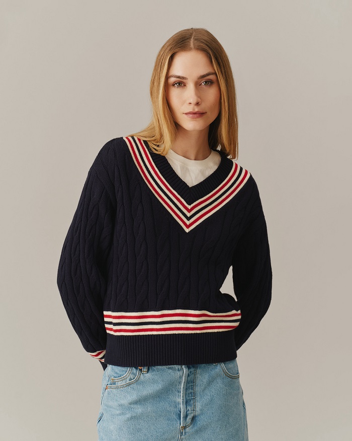 Woman in navy cricket v-neck cable sweater